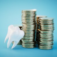 Tooth next to some coins in Midwest City