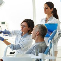 Patient talking to dentist about tooth extractions in Midwest City