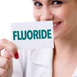 Close up of woman holding a fluoride card